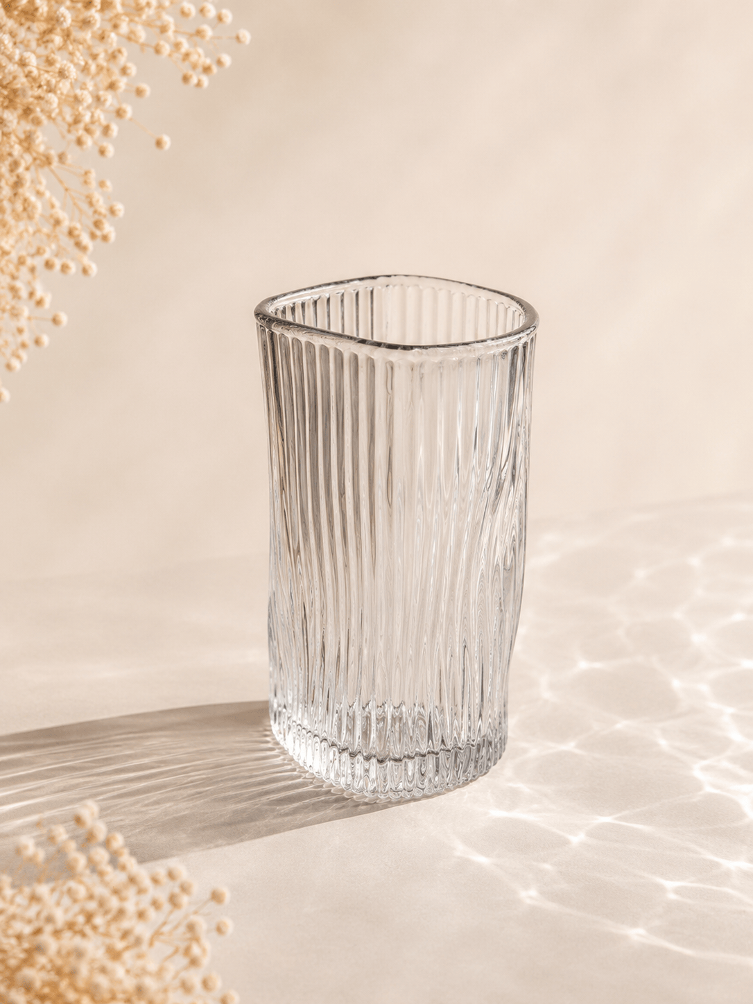 Douze verres à eau en verre transparent de la marque HomeDeLuxe, design élégant pour servir de l'eau.